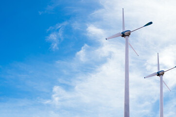 Wind mill power energy farm generator renewable sustainable field on blue sky, environment eco system technology industry ecology electricity power propeller turbine clean carbon. © wing-wing