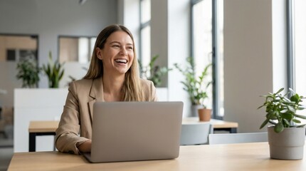 Happy confident professional working on laptop in modern workspace