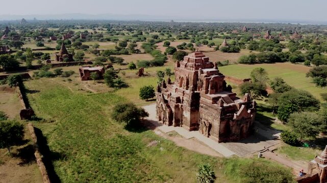 Experience the vast expanse of temples and lush greenery in Bagan, Myanmar. Discover the rich history and serene beauty of this UNESCO World Heritage site as the sunlight bathes the landscape.