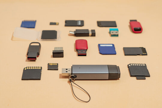Collection of USB flash drives, SD and microSD memory cards on a clean background, selective focus. Digital storage, data transfer, backup and modern technology. Rising prices for storage media