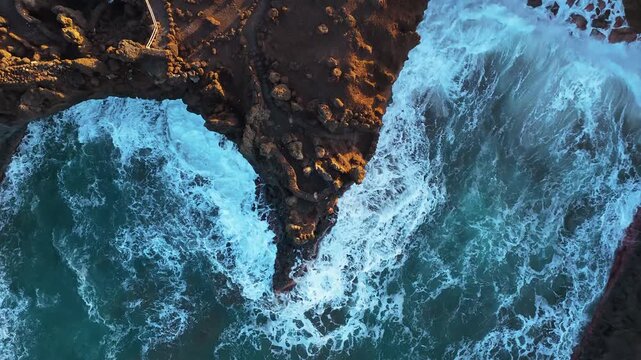Los Hervideros is a dramatic stretch of volcanic coastline in Yaiza, Lanzarote, where the Atlantic Ocean crashes into sea caves and basaltic cliffs. Formed during the Timanfaya eruptions between 1730 