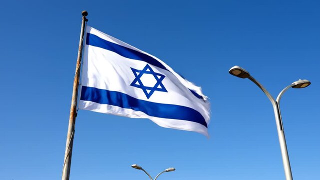Israeli flag waving in blue sky