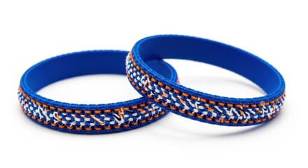 Fototapeta premium Two vibrant blue silicone bracelets with intricate woven patterns displayed against a white background