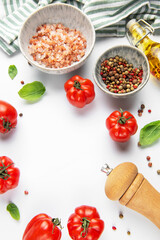 Fresh tomatoes, herbs, and spices on white background
