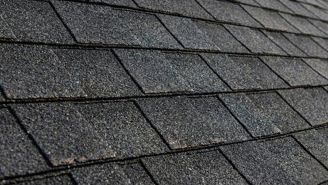 Grey asphalt roof shingles texture background