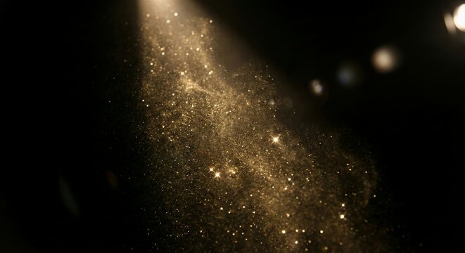 Abstract background of exploding gold and copper glitter particles against a dark backdrop.