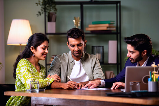 Indian Asian couple Home loan contract signing with banker during property purchase process