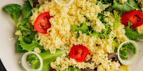 Couscous salad vegetables tomato, onion, green lettuce leaves food preparation tasty snack fresh delicious gourmet food background on the table rustic food top view copy space keto and paleo diet  