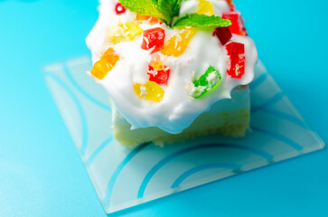 A colorful dessert with a green mint leaf on top © Q77photo