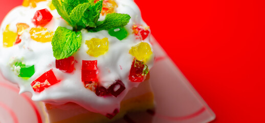 A colorful dessert with a green mint leaf on top © Q77photo