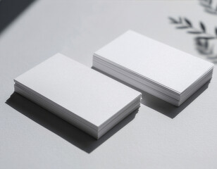 Stack of blank white business cards mockup on a gray surface
