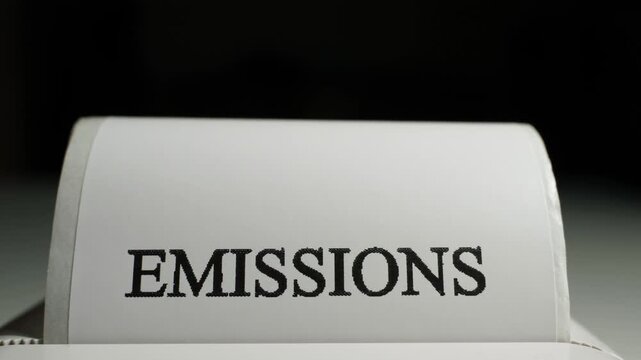 Printing a sticker with the word EMISSIONS, close-up