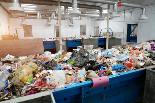 Room with a waste conveyor for the primary manual selection of various types and fractions of household waste from human activity at a waste processing plant