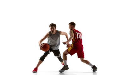 Obraz premium Basketball player changing direction while defender follows on white background. Concept of basketball promo, youth training enrollment, sports academy websites and athletic performance programs.