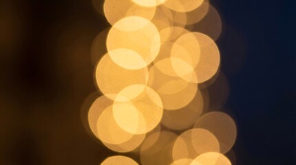 Blurry golden lights against a dark background, festive atmosphere.