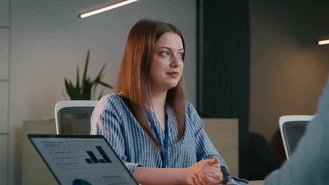 Businesswoman listening to a colleague during an office meeting