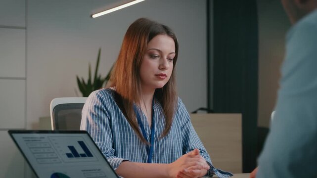 Unhappy businesswoman receiving bad news from a colleague