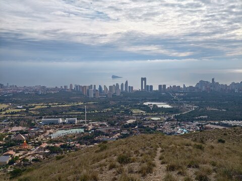 Vast hillside panorama showcasing rapid growth and development within coastal urban environment