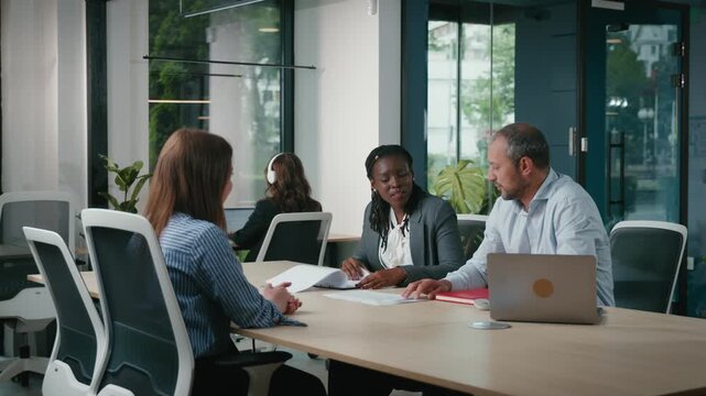 Diverse corporate team collaborating in office meeting