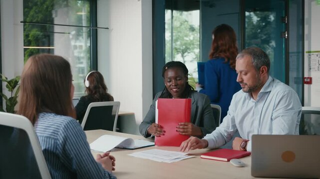 Diverse business team discussing project in modern office