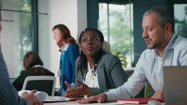 Diverse business team discussing project during corporate meeting