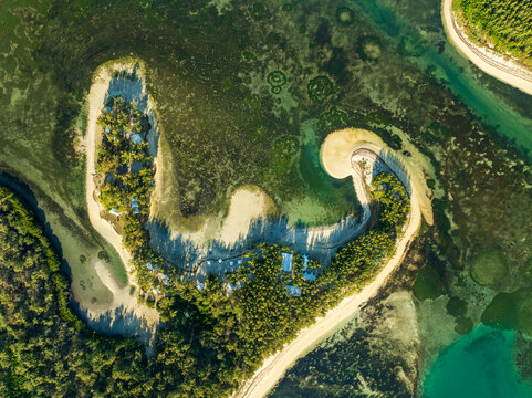Aerial view of the Shangri La coastline, where the turquoise waters meet the sandy shores in a breathtaking display of natural beauty, Shangri La, Trou d'Eau Douce, Mauritius.