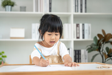Naklejka premium Asia children playing learning paint on paper. Activity, development, IQ, EQ, meditation, brain, muscles, essential skills, family having fun spending time together. Holiday