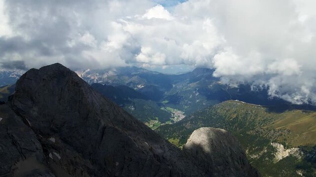 Remote Summit Offering Breathtaking Views Of Rugged Terrain Beneath Shifting Cloud Formations And Open Skies