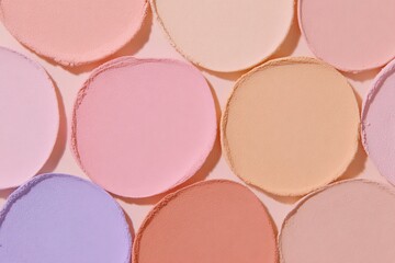 Fototapeta premium Soft colored circles arranged on a flat surface create a playful scene during daytime light