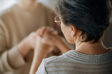 Fototapeta premium Caring Touch Between Generations: Hands in Warm Connection