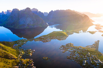 Aerial view of Norwegian fjord village with mountains at sunset, Lofoten islands