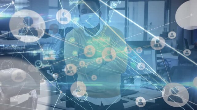 Animation of network of connections with icons over african american businessman with face mask