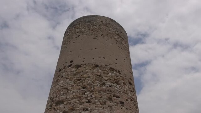 Tower Mora old stone cloudy overcast sky wind medieval historical low angle