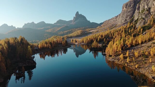 Scenic autumn landscape of Lago di Federa with Croda da Lago peak surrounded by larch forest in Dolomites, Italy