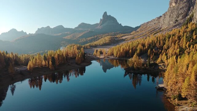 Scenic autumn landscape of Lago di Federa with Croda da Lago peak surrounded by larch forest in Dolomites, Italy