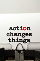 Fototapeta premium Action changes things text typed on retro typewriter. Message printed on paper motivates doing things and progress. Motivating quote for business or personal growth.