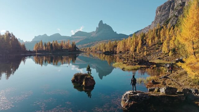 Scenic autumn landscape of Lago di Federa with Croda da Lago peak surrounded by larch forest in Dolomites, Italy