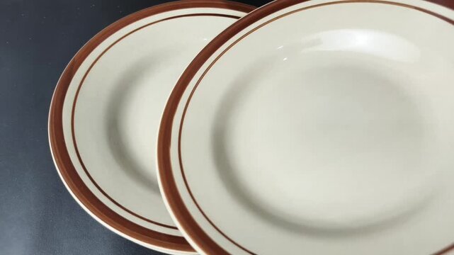 Stacking Ceramic Plates on the Table &ndash; Close-up of a Minimalist Kitchen Background
