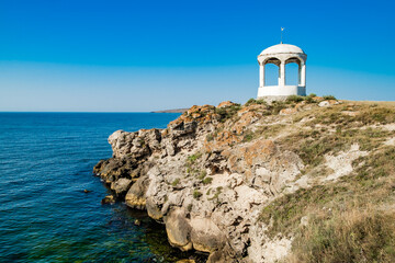 stone gazebo on the rocky shore