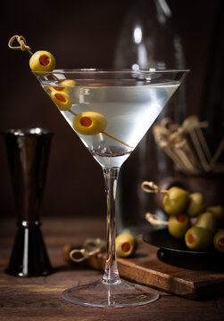 Martini cocktail with olives on a bamboo pick