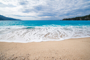 Fototapeta premium sandy coast and turquoise water in the sea, wide angle