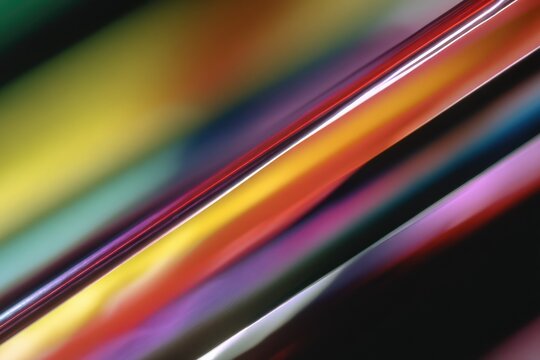 a close up of an abstract background with colorful lines, rainbow colors, blurred imagery, motion blur.