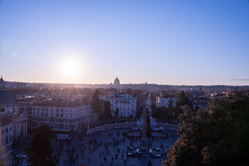 Fototapeta premium Rome at dusk, where the sky melts from gold to rose to deep violet, and every rooftop catches fire for a moment before the night gently steals the light.