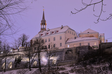 Medieval buildings in downtown Tallinn, Estonia at night, low angle view from the park outside the city walls
