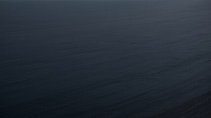 Fototapeta premium Dark textured surface with subtle gradient effect