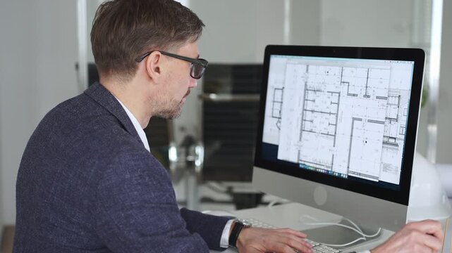 Architect developing building blueprint on computer, engineering and urban planning a new construction project. Business and architecture concept