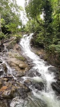 Stunning multi tiered Curug Bibijilan waterfall with emerald green water in Sukabumi, Indonesia.