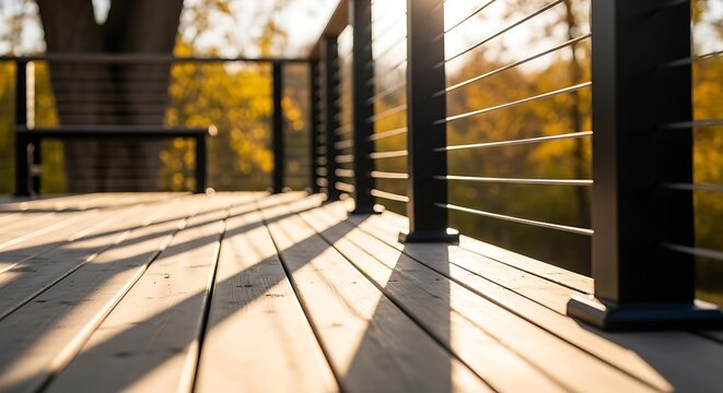 Wooden deck with metal railing in warm light. Outdoor living space for home and leisure. Cozy backyard design element.