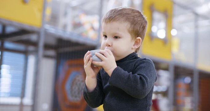 A boy inflates a plastic ball at the kids club