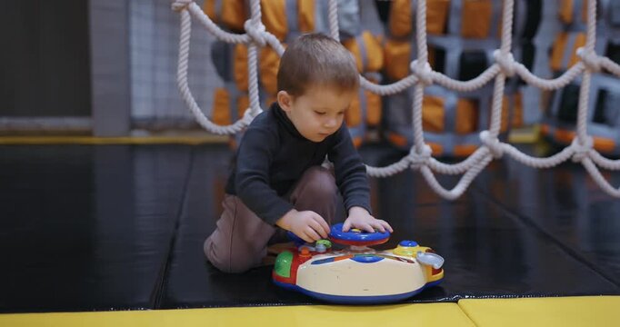 A boy plays with toys at the kids club